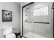 Modern bathroom with glass-enclosed shower and gray wall accents at 1127 W Webb Ave, Burlington, NC 27217