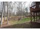 Spacious backyard with wood fence, fire pit area, and a wooden deck visible from the house at 113 Hawkscrest Ct, Apex, NC 27502