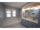 Bright bathroom with double vanity, soaking tub, and large window at 113 Hawkscrest Ct, Apex, NC 27502