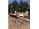 Beautiful community sign for Scotts Mill with landscaped flower bed and manicured greenery at 113 Hawkscrest Ct, Apex, NC 27502