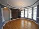 Spacious dining room with a rustic accent wall and bay windows that let in ample light at 113 Hawkscrest Ct, Apex, NC 27502
