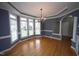 Charming dining room with hardwood floors, elegant light fixture, and bay windows at 113 Hawkscrest Ct, Apex, NC 27502