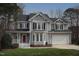 Charming two-story home featuring gray siding, black shutters, and a well-manicured lawn at 113 Hawkscrest Ct, Apex, NC 27502