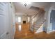 Bright foyer featuring hardwood floors, a staircase, and an open view to the living room at 113 Hawkscrest Ct, Apex, NC 27502