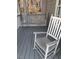 Cozy front porch with a rocking chair and a porch swing, perfect for relaxing at 113 Hawkscrest Ct, Apex, NC 27502