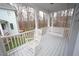 Spacious front porch with a rocking chair and swing overlooking a wooded lot at 113 Hawkscrest Ct, Apex, NC 27502