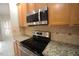 Well-equipped kitchen with stainless steel appliances and granite countertops at 113 Hawkscrest Ct, Apex, NC 27502