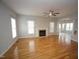 Open living room showcases hardwood floors, a fireplace, and access to the kitchen and dining area at 113 Hawkscrest Ct, Apex, NC 27502