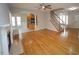Spacious living room with hardwood floors leading to the kitchen and staircase at 113 Hawkscrest Ct, Apex, NC 27502
