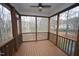 Relaxing screened porch with wood flooring, offering a serene outdoor living space at 113 Hawkscrest Ct, Apex, NC 27502