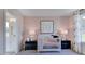 Adorable Bedroom showcasing a crib, soft pink wallpaper, and matching lamps at 1133 Sun Springs Rd, Wake Forest, NC 27587