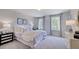 Bright bedroom with plush carpet, two windows, and stylish accent pieces at 1133 Sun Springs Rd, Wake Forest, NC 27587