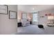 Charming Bedroom featuring a crib, pink patterned wallpaper, and soft lighting at 1133 Sun Springs Rd, Wake Forest, NC 27587