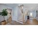 Open entryway with a plant, wood floors and a staircase leading to the second level at 1133 Sun Springs Rd, Wake Forest, NC 27587