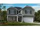 Charming two-story home features a clean color palette, attached garage, and manicured lawn at 1133 Sun Springs Rd, Wake Forest, NC 27587