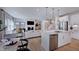 Open-concept living space with stainless appliances, fireplace, and comfortable seating arrangement at 1133 Sun Springs Rd, Wake Forest, NC 27587
