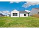 Back of the house, with a spacious lawn and a backyard featuring big windows at 1794 Parham Dr, Graham, NC 27253