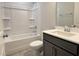 Bathroom features neutral colors, with white tub and vanity at 1794 Parham Dr, Graham, NC 27253