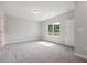 Spacious bedroom featuring neutral carpet, a window for natural light, and a modern ceiling light at 1794 Parham Dr, Graham, NC 27253