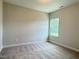 New bedroom features neutral walls, carpet, and a large window for natural light at 1794 Parham Dr, Graham, NC 27253