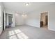 Open bedroom space with neutral carpet and natural light coming through a pair of windows at 1794 Parham Dr, Graham, NC 27253