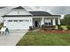 Charming one-story home featuring a white exterior, black door, attached garage and well-maintained front yard at 1794 Parham Dr, Graham, NC 27253