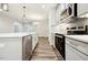 Modern kitchen with stainless steel appliances, white countertops, and a subway tile backsplash at 1794 Parham Dr, Graham, NC 27253