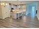 Modern kitchen with a center island, stainless appliances, gray cabinets, and elegant lighting at 1794 Parham Dr, Graham, NC 27253