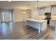 Open-concept kitchen boasts a large center island, stainless steel appliances, and modern gray cabinets at 1794 Parham Dr, Graham, NC 27253