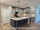 Bright eat-in kitchen featuring stainless appliances, granite countertops, and gray cabinets at 1794 Parham Dr, Graham, NC 27253