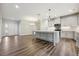 Open-concept kitchen featuring a large island, modern appliances, and pendant lighting at 1794 Parham Dr, Graham, NC 27253