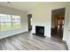 Inviting living room with a fireplace, large windows, and hardwood-style floors, offering plenty of natural light at 1794 Parham Dr, Graham, NC 27253