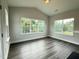 Bright living room with large windows, vaulted ceiling and wood-look floors for a modern touch at 1794 Parham Dr, Graham, NC 27253