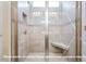 Walk-in shower featuring tiled walls, glass doors, and a built-in seat at 1794 Parham Dr, Graham, NC 27253