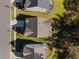 An aerial shot captures a birds-eye perspective of three houses with perfectly manicured lawns at 204 Woodstaff Ave, Wake Forest, NC 27587