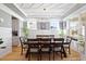 Elegant dining room featuring a modern light fixture and large windows for ample natural light at 204 Woodstaff Ave, Wake Forest, NC 27587