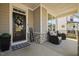 Cozy front porch with comfortable seating, a welcome mat, and a charming wreath on the door at 204 Woodstaff Ave, Wake Forest, NC 27587