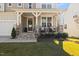 Inviting front porch with stone accents, cozy seating, and a charming welcome wreath at 204 Woodstaff Ave, Wake Forest, NC 27587
