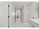 Hallway with marble floors and white walls, leading to a bedroom with hardwood floors at 204 Woodstaff Ave, Wake Forest, NC 27587