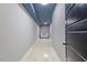 Bright hallway with painted concrete floor and blue-accented ceilings and recessed lighting at 204 Woodstaff Ave, Wake Forest, NC 27587