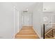 Bright hallway with hardwood floors, white trim, and contemporary lighting fixtures creating a welcoming path at 204 Woodstaff Ave, Wake Forest, NC 27587