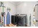 Modern laundry room equipped with new washer and dryer appliances and convenient storage solutions at 204 Woodstaff Ave, Wake Forest, NC 27587