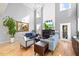 Grand living room with high ceilings, a modern fireplace, and stylish furniture arrangements at 204 Woodstaff Ave, Wake Forest, NC 27587