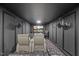 Home theater room with tiered seating, projector screen, galaxy-themed carpet, and sconce lighting at 204 Woodstaff Ave, Wake Forest, NC 27587