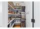 Walk-in pantry with organized shelving, baskets, and ample storage space for kitchen essentials at 204 Woodstaff Ave, Wake Forest, NC 27587