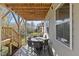 Covered patio features outdoor seating and stairs leading to the yard at 204 Woodstaff Ave, Wake Forest, NC 27587
