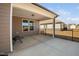 Relaxing covered back porch area offering a view of a fenced backyard in a residential neighborhood at 2109 Flycatcher Ln, Fuquay Varina, NC 27526