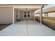 Spacious covered back porch with concrete flooring, ideal for outdoor seating and relaxation at 2109 Flycatcher Ln, Fuquay Varina, NC 27526