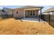 Backyard and patio view of home featuring decorative urns and black metal fence at 2109 Flycatcher Ln, Fuquay Varina, NC 27526