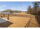 Fenced backyard with decorative urns and view of other homes at 2109 Flycatcher Ln, Fuquay Varina, NC 27526